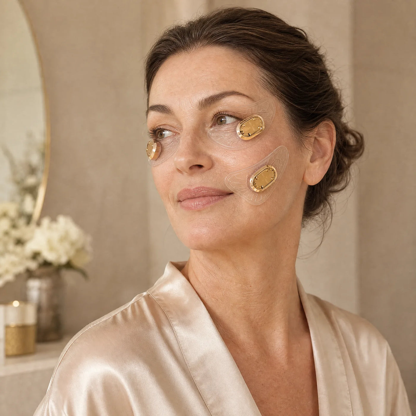 Woman wearing EMSTIGHT EMS Microcurrent Eye and Cheek Patches at home