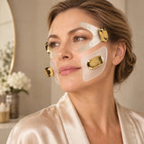 Woman in a silk robe wearing the EMSTIGHT EMS Eye and Cheek Patches, with gold host units at the eye and cheek